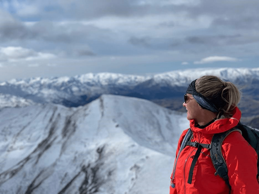 Person looking over snow covered moutain tops. Person looking over snow covered moutain tops.
