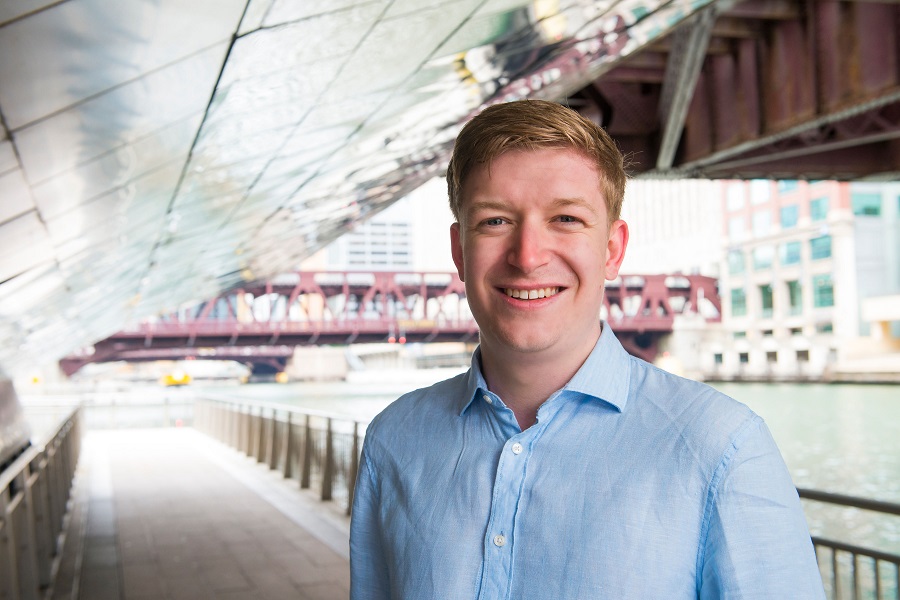 Young man in blue shirt standing under a bridge Young man in blue shirt standing under a bridge