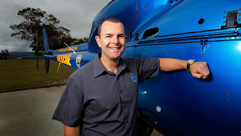 Person standing next to a helicopter. Person standing next to a helicopter.