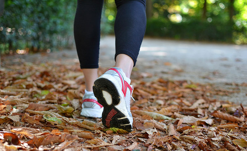 Close up of someone's feet as they walk in active wear. Close up of someone's feet as they walk in active wear.