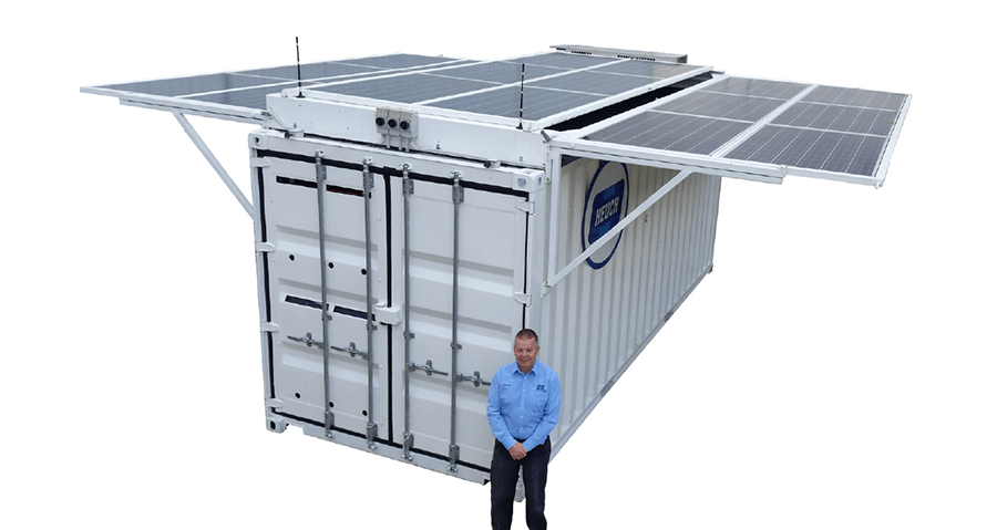 Steve Oakley, standing in front of a white shipping container with solar panels on the top. Steve Oakley, standing in front of a white shipping container with solar panels on the top.
