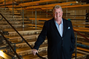 Man standing in front of Canberra's Nishi building wooden staircase. Man standing in front of Canberra's Nishi building wooden staircase.