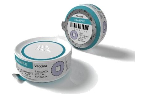 The image shows two round, blue and white vaccine containers: the Nanopatch The image shows two round, blue and white vaccine containers: the Nanopatch