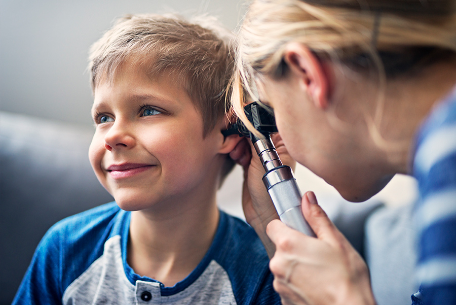 photo of child with doctor inspoecting childs ear
