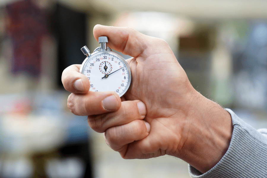 A hand holding a stopwatch